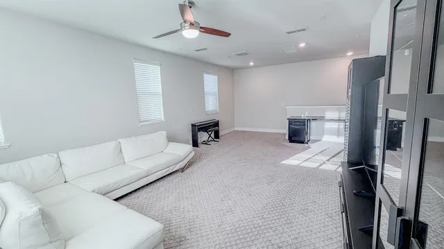 a bedroom with a bed a couch and a window