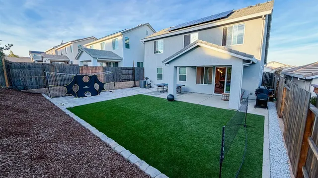 a view of a patio with a table and chairs