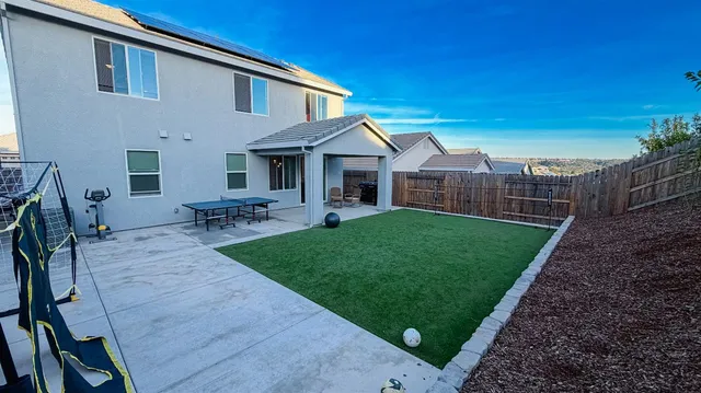 a view of an house with backyard porch and furniture