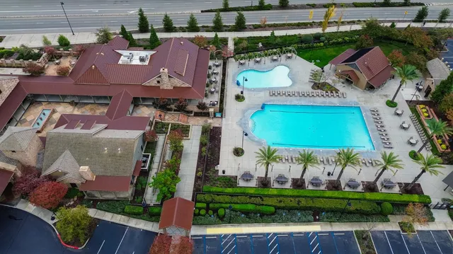 a view of a patio with a table and chairs under an umbrella