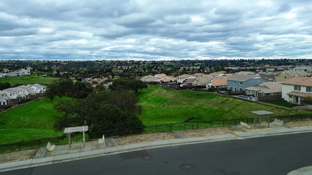 a view of a garden with a building in the background