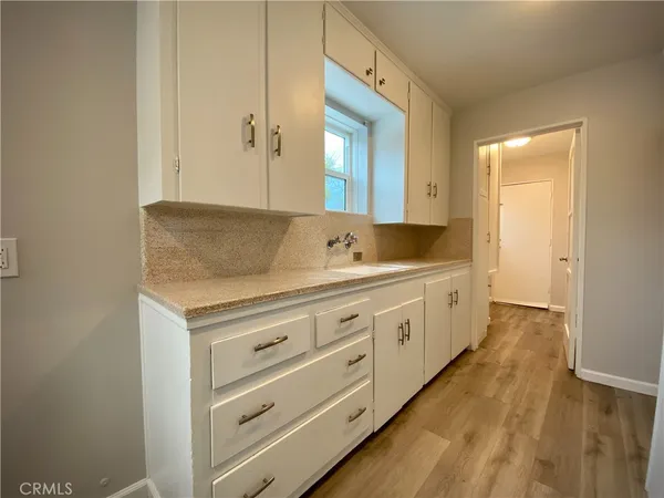 a spacious bathroom with a granite countertop sink and a mirror