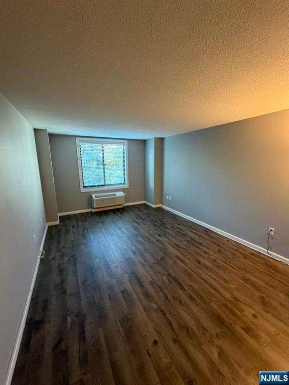 115 Polifly Road, Unit 5D Hackensack, NJ 07601 - Photo 7 of 10 an empty room with wooden floor and windows