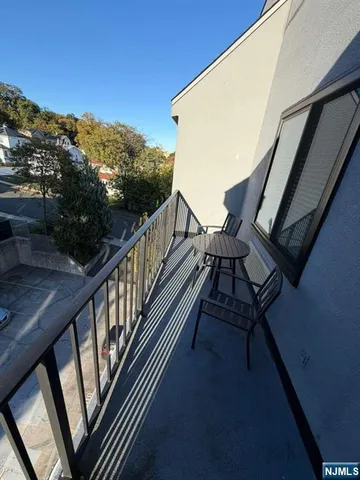 a view of balcony with wooden floor and fence