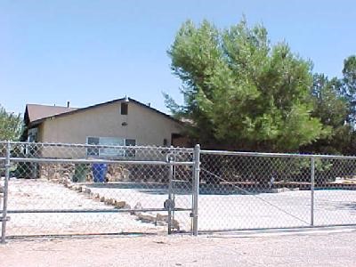 21330 Multnomah Road Apple Valley, CA 92308 - Photo 1 of 1 a front view of a house with a yard