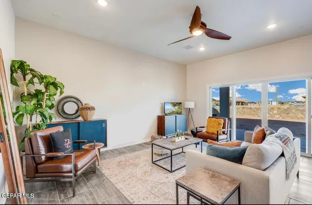 a living room with furniture and wooden floor