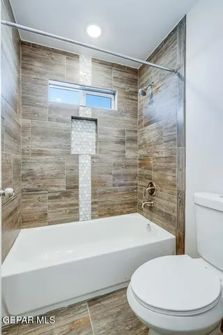 a bathroom with a toilet and a bathtub