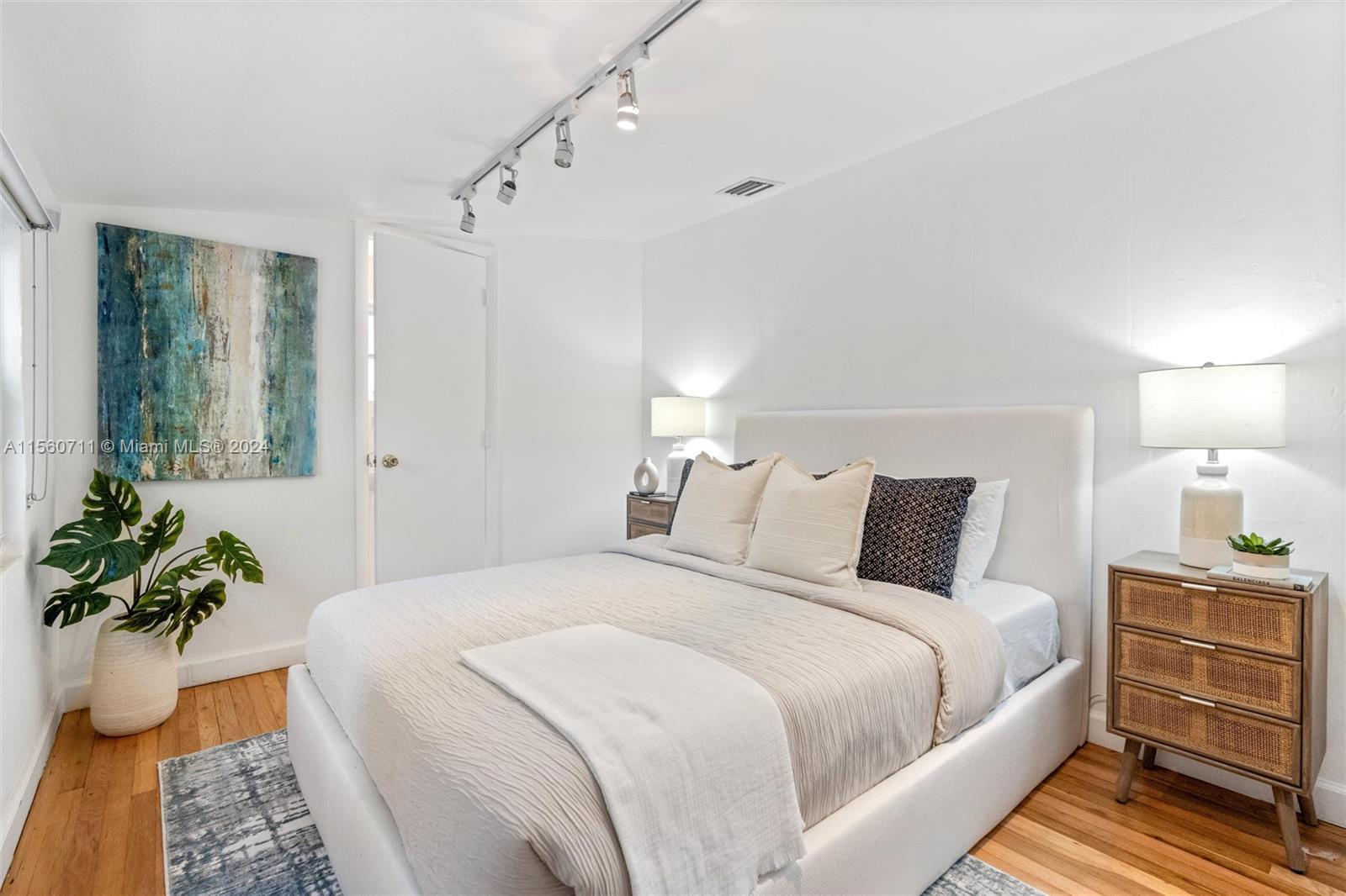 335 Southwest 31st Road Miami, FL 33129 - Photo 11 of 20 a bedroom with bed and a potted plant