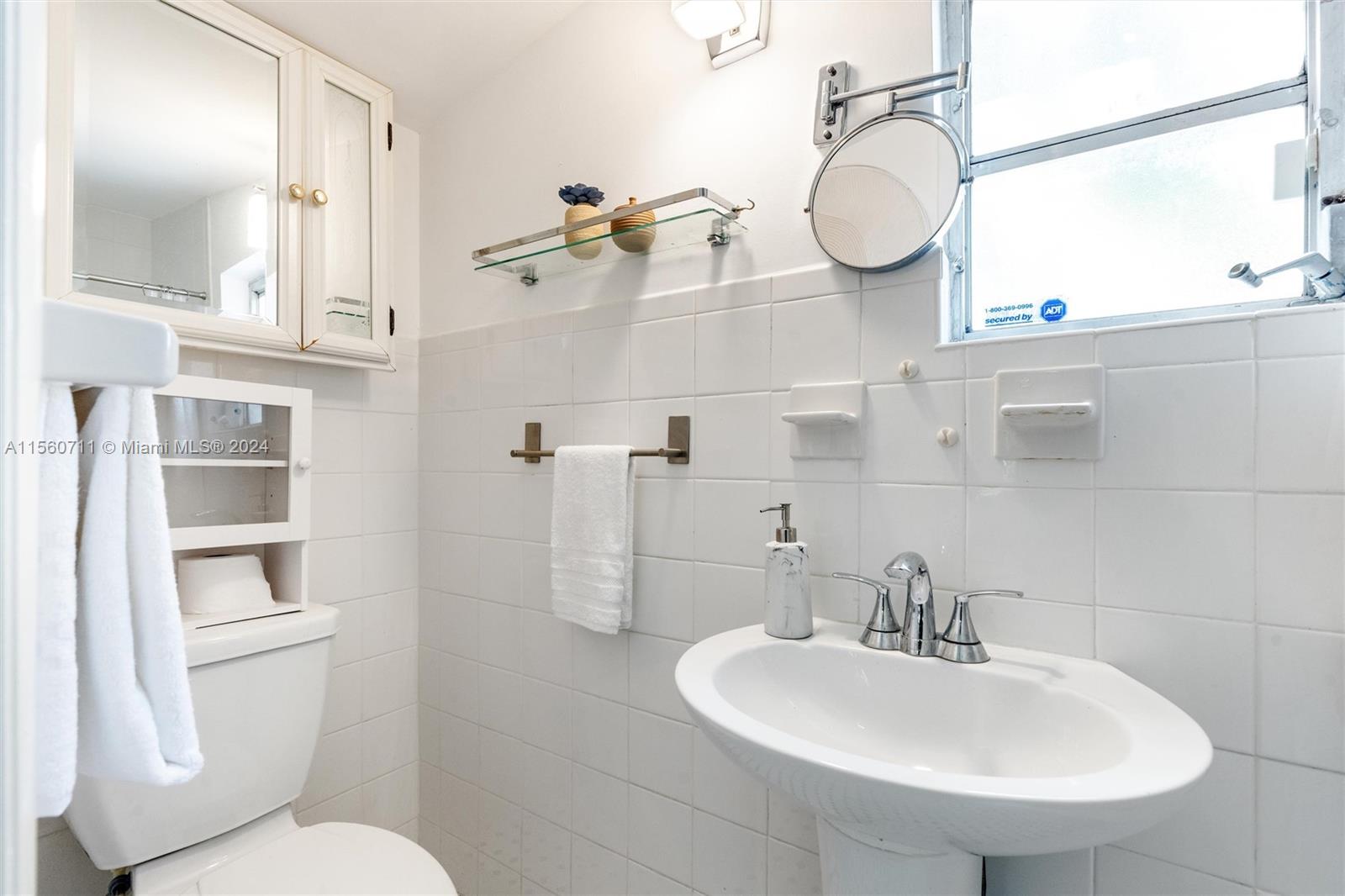 335 Southwest 31st Road Miami, FL 33129 - Photo 14 of 20 a bathroom with a sink a toilet and a mirror