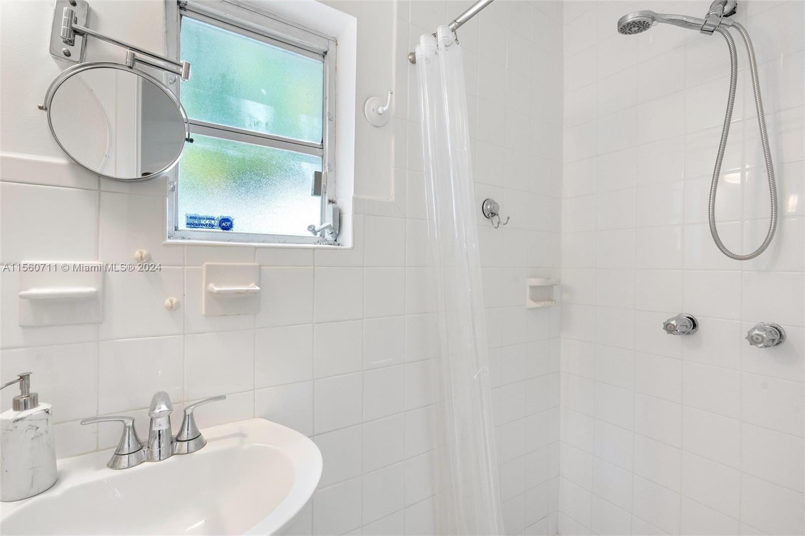 335 Southwest 31st Road Miami, FL 33129 - Photo 15 of 20 a bathroom with a sink and a mirror
