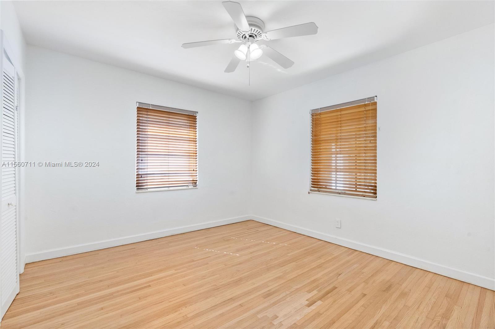 335 Southwest 31st Road Miami, FL 33129 - Photo 16 of 20 a view of an empty room with wooden floor and a window