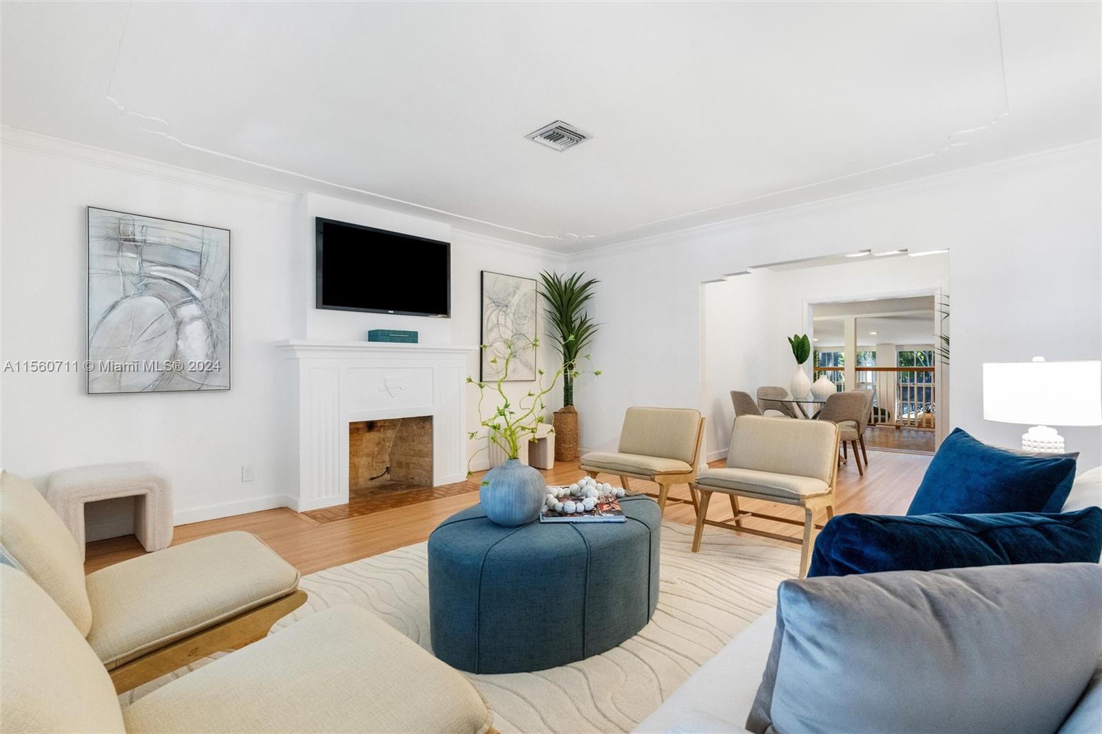 335 Southwest 31st Road Miami, FL 33129 - Photo 3 of 20 a living room with furniture a fireplace and a flat screen tv