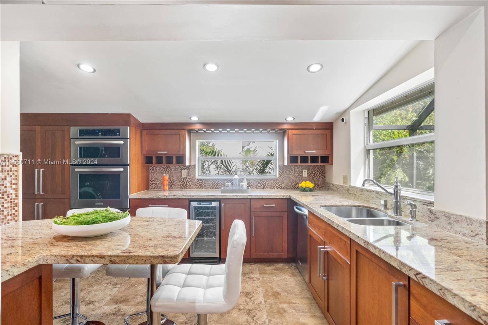 335 Southwest 31st Road Miami, FL 33129 - Photo 8 of 20 a kitchen with granite countertop lots of counter top space and dining table