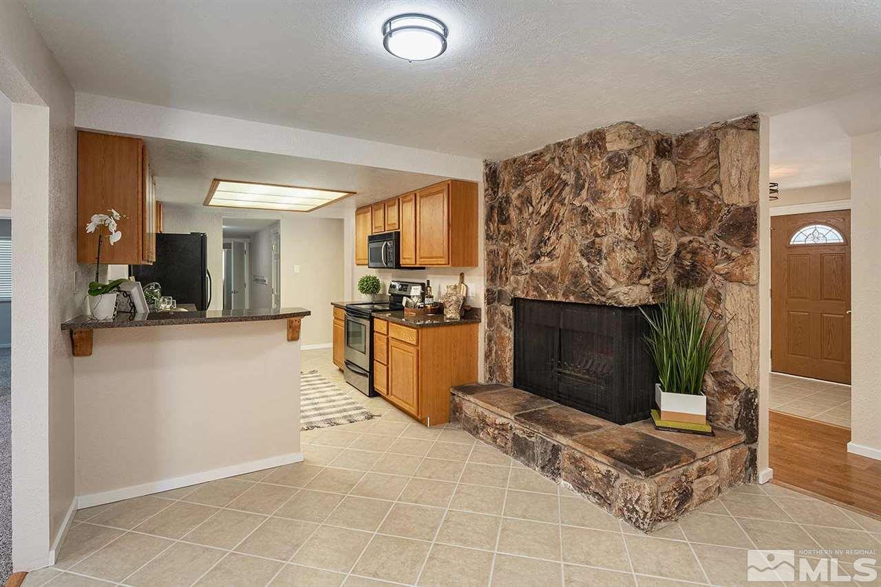 3165 Reanon Court Reno, NV 89509 - Photo 3 of 25 a view of a living room kitchen and a fireplace