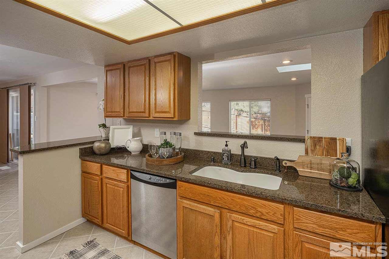 3165 Reanon Court Reno, NV 89509 - Photo 9 of 25 a bathroom with sinks granite countertop a sink and a mirror