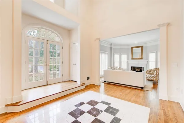 a living room with fireplace furniture and a large window