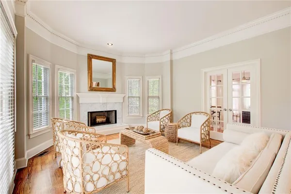 a living room with furniture a fireplace and a large window