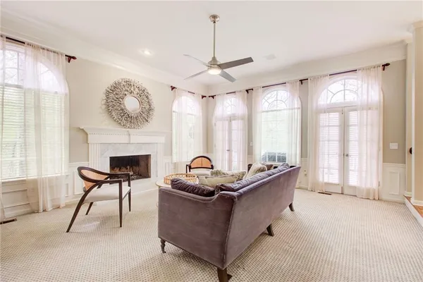 a view of a dining room with furniture a chandelier and wooden floor