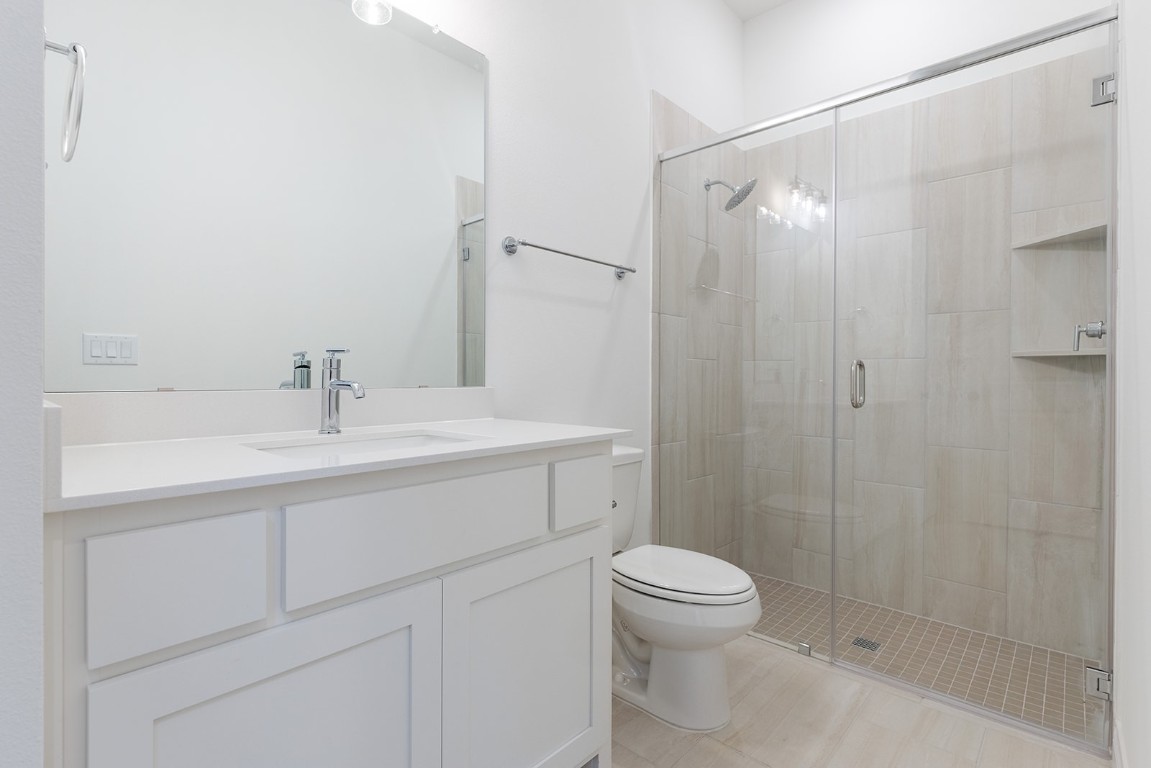 4608 Destination Way Jonestown, TX 78645 - Photo 18 of 29 a bathroom with a shower sink vanity and toilet
