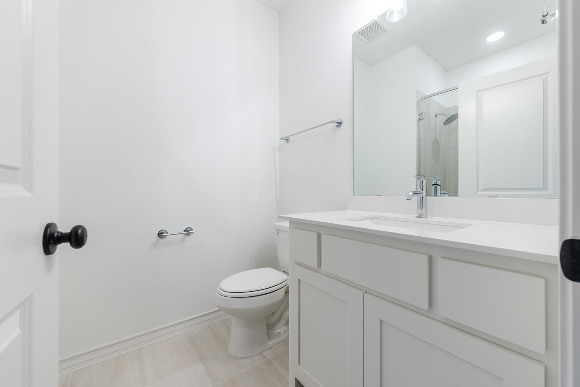 4608 Destination Way Jonestown, TX 78645 - Photo 19 of 29 a bathroom with a sink a toilet and shower
