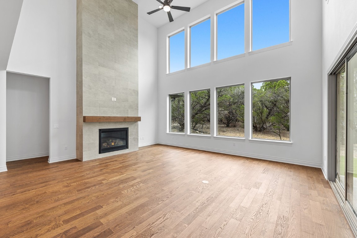 4608 Destination Way Jonestown, TX 78645 - Photo 4 of 29 a view of an empty room with a window and wooden floor