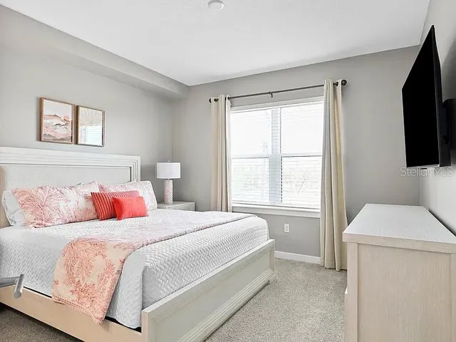 a bedroom with a bed and a dresser