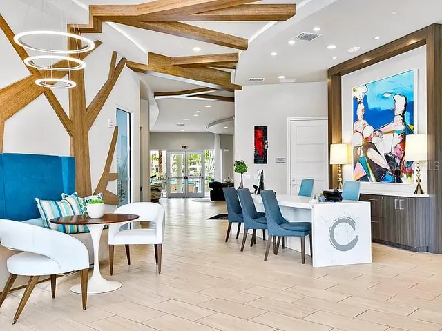 a view of a dining room with furniture and a chandelier