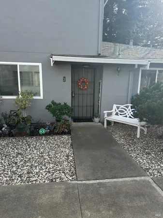a wooden bench sitting in front of a building