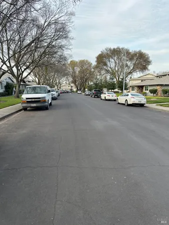 a view of street with parked cars