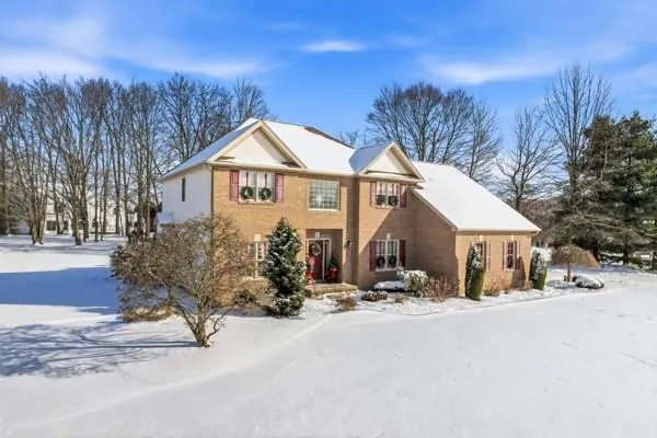 a view of house with a yard covered in snow