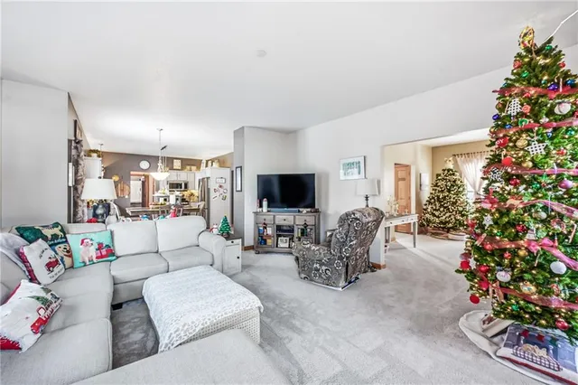 a living room with furniture and a flower garden