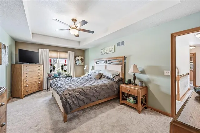 a bedroom with a bed window and a flat screen tv