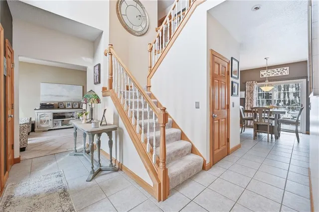 a view of a dining room with furniture and chandelier