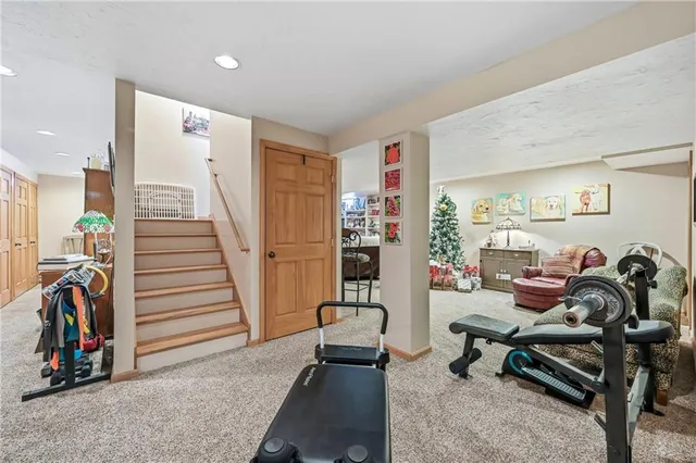 a living room with furniture a air conditioner and a window