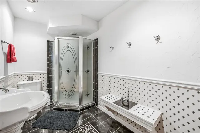 a bathroom with a sink a mirror and a shower