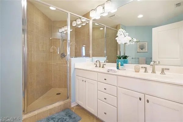 a bathroom with a shower sink double and mirror