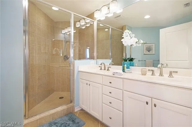 a bathroom with a shower sink double and mirror