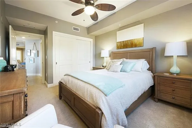 a spacious bedroom with a bed and a chandelier