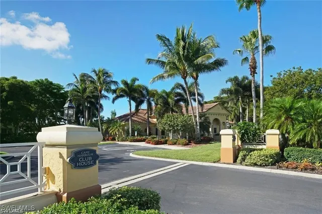 a view of a patio with dining table and chairs plants and palm trees
