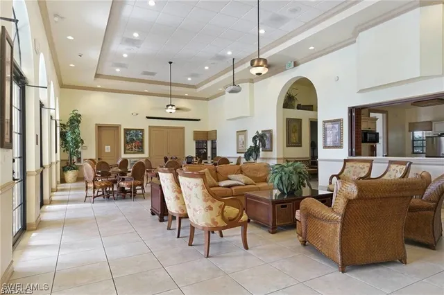 a living room with patio furniture and a chandelier