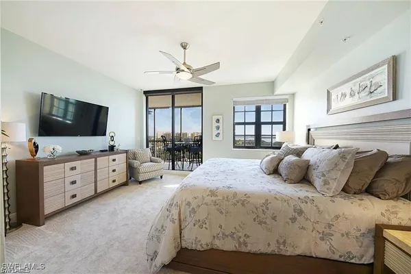 a bedroom with a large bed and a flat screen tv