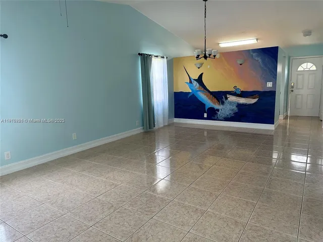 a view of a big room with wooden floor and a ceiling fan