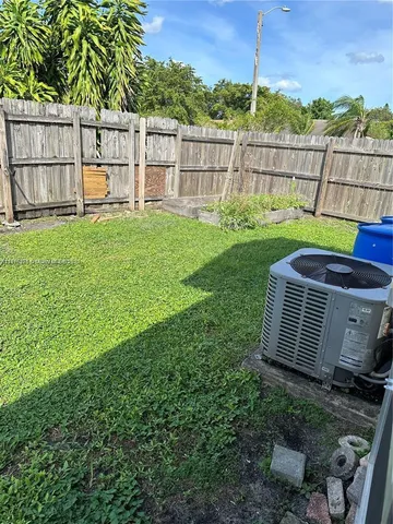 a view of a yard with a fence