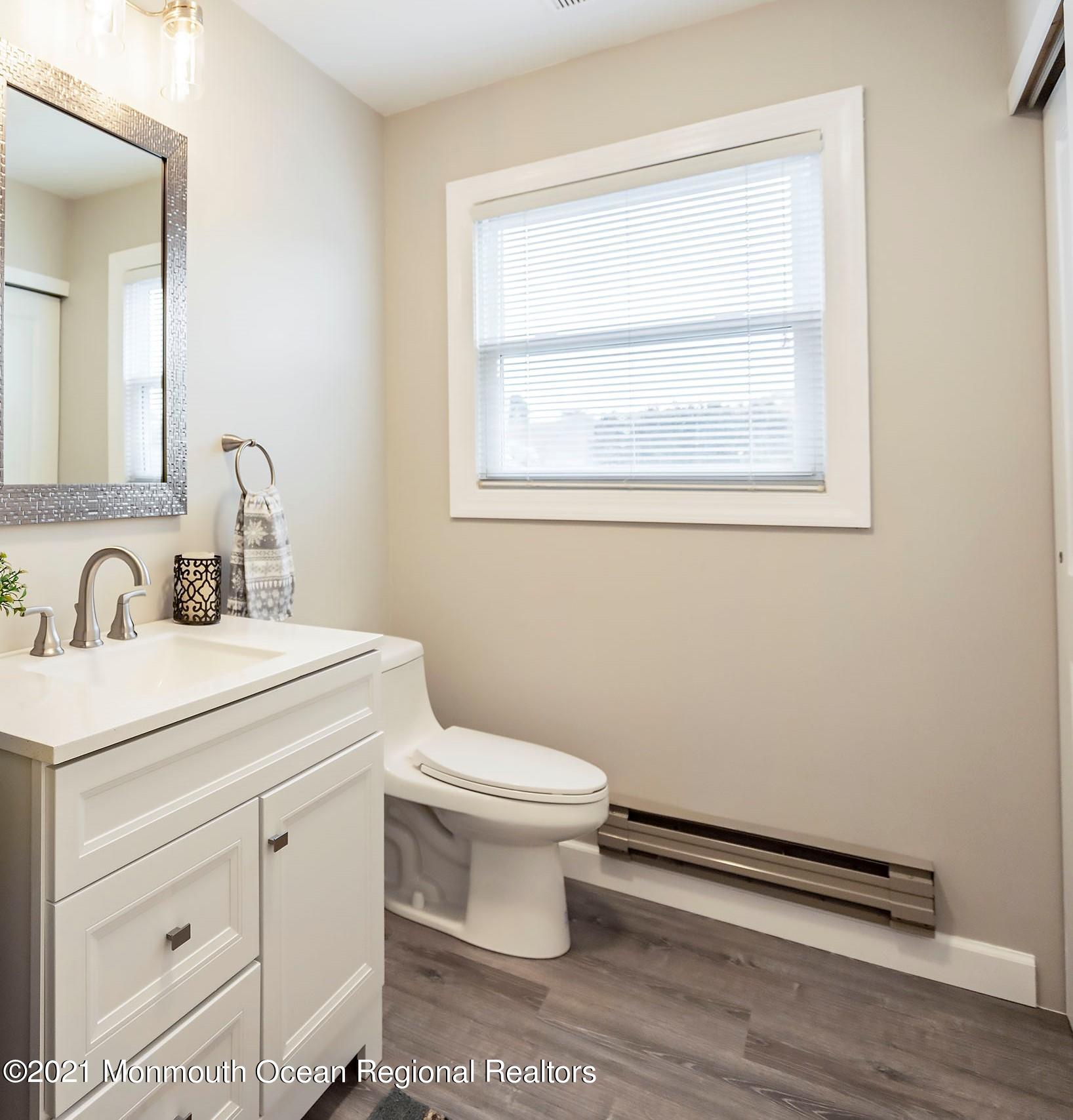 17 Berry Hill Road Whiting, NJ 08759 - Photo 18 of 26 a bathroom with a toilet sink and mirror
