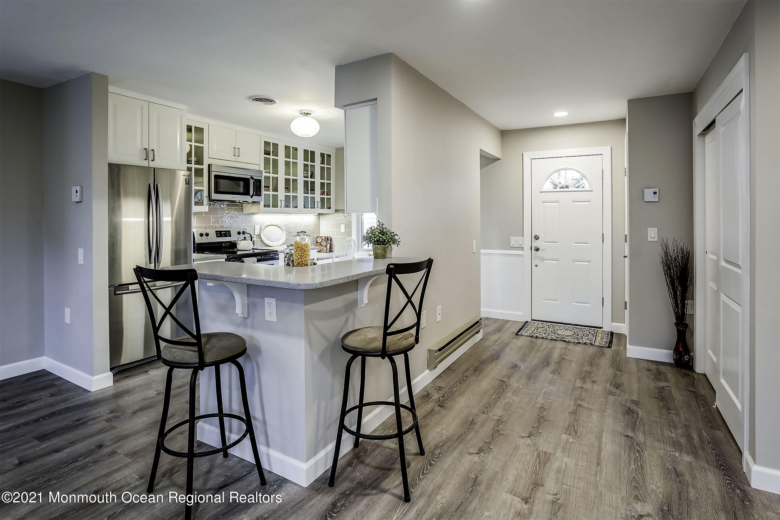 17 Berry Hill Road Whiting, NJ 08759 - Photo 9 of 26 a kitchen with stainless steel appliances a dining table chairs refrigerator and sink