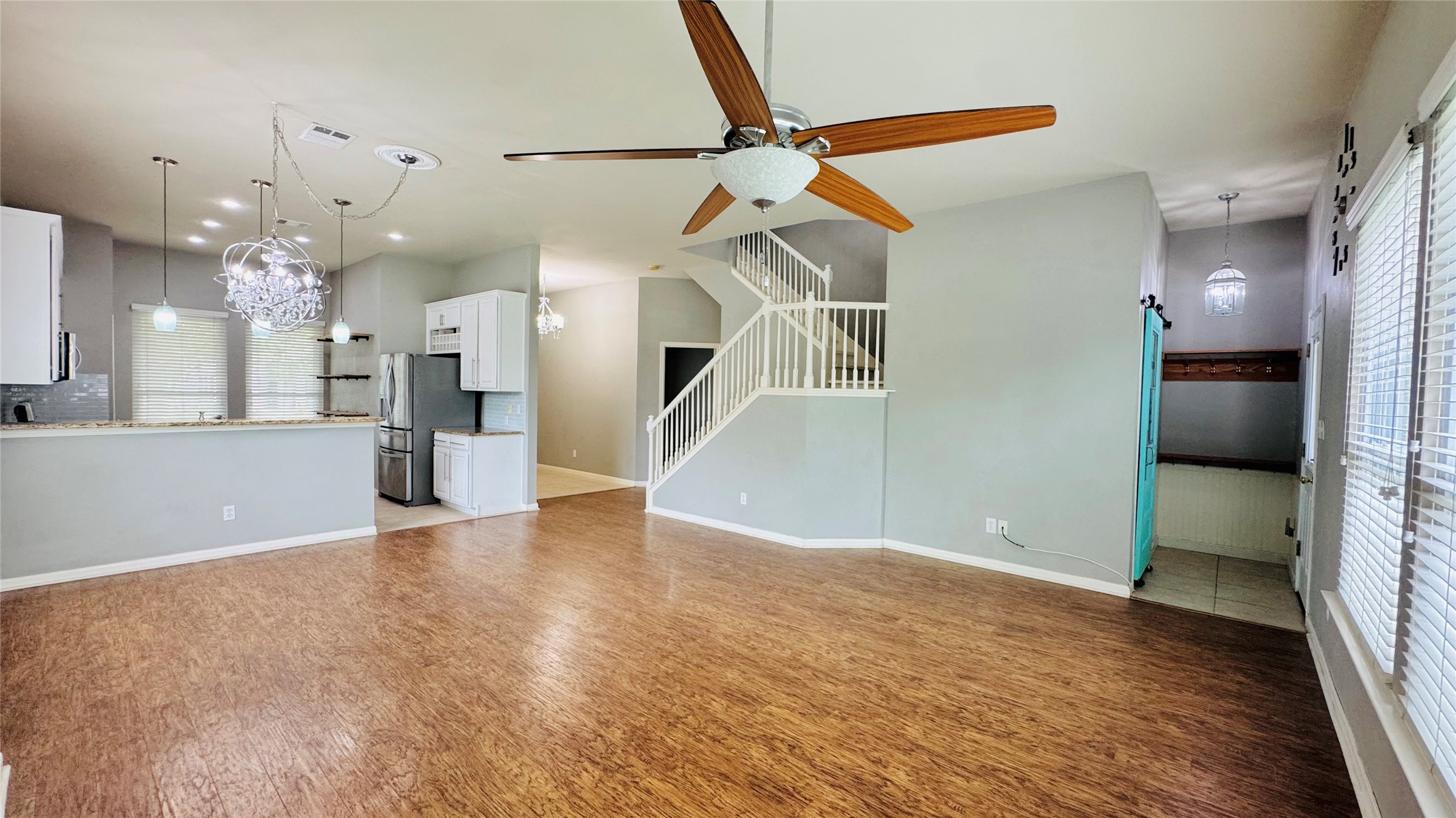 401 Witte Road Kyle, TX 78640 - Photo 5 of 24 A vibrant living space with rich wood flooring and an open-concept layout.