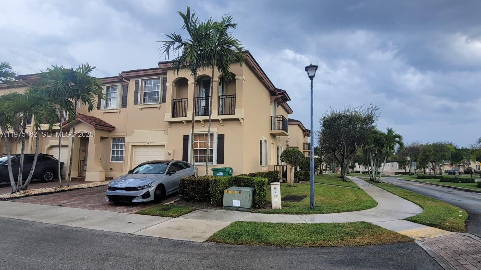 12842 Southwest 134th Street Miami, FL 33186 - Photo 1 of 22 a front view of a house with garden