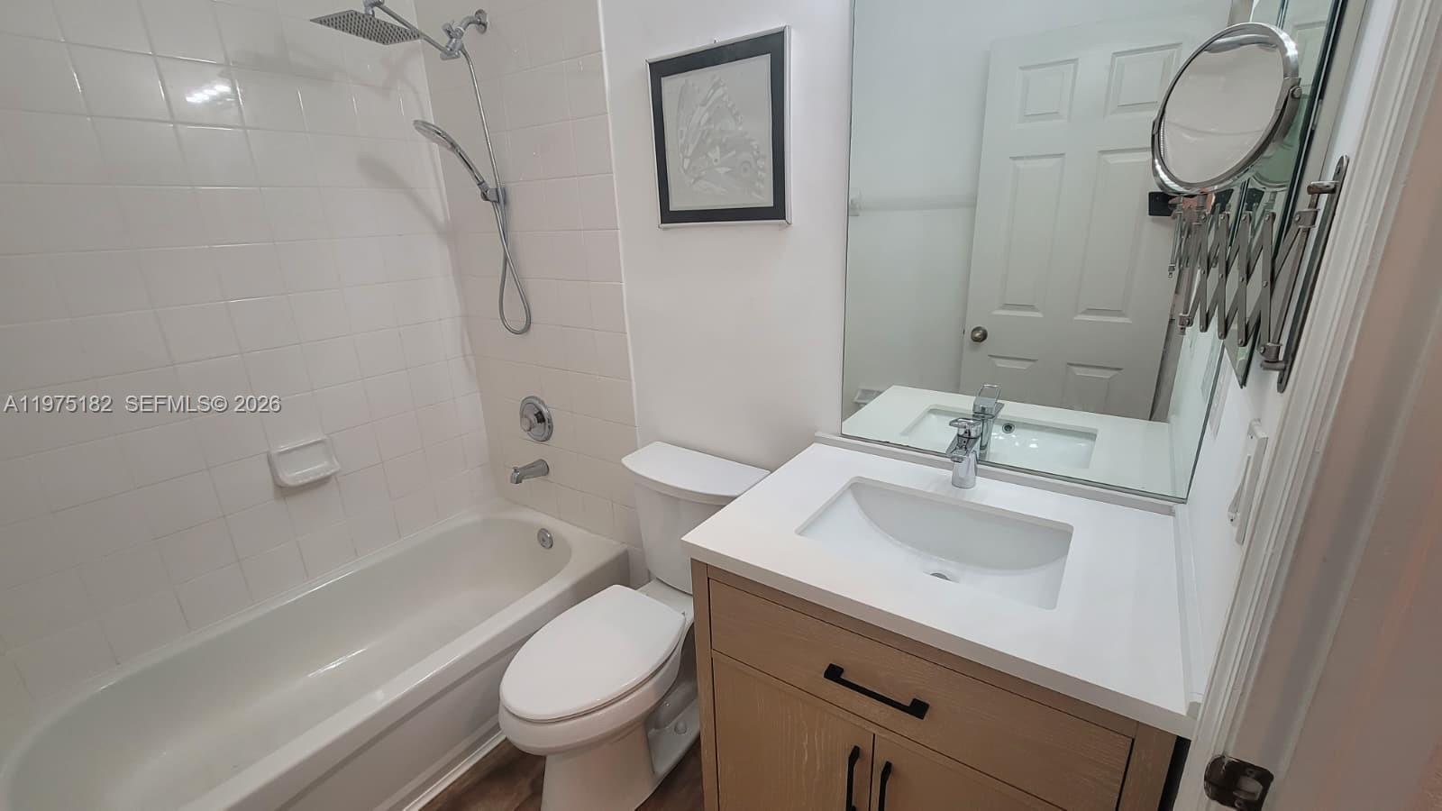 12842 Southwest 134th Street Miami, FL 33186 - Photo 13 of 22 a bathroom with a sink toilet and shower