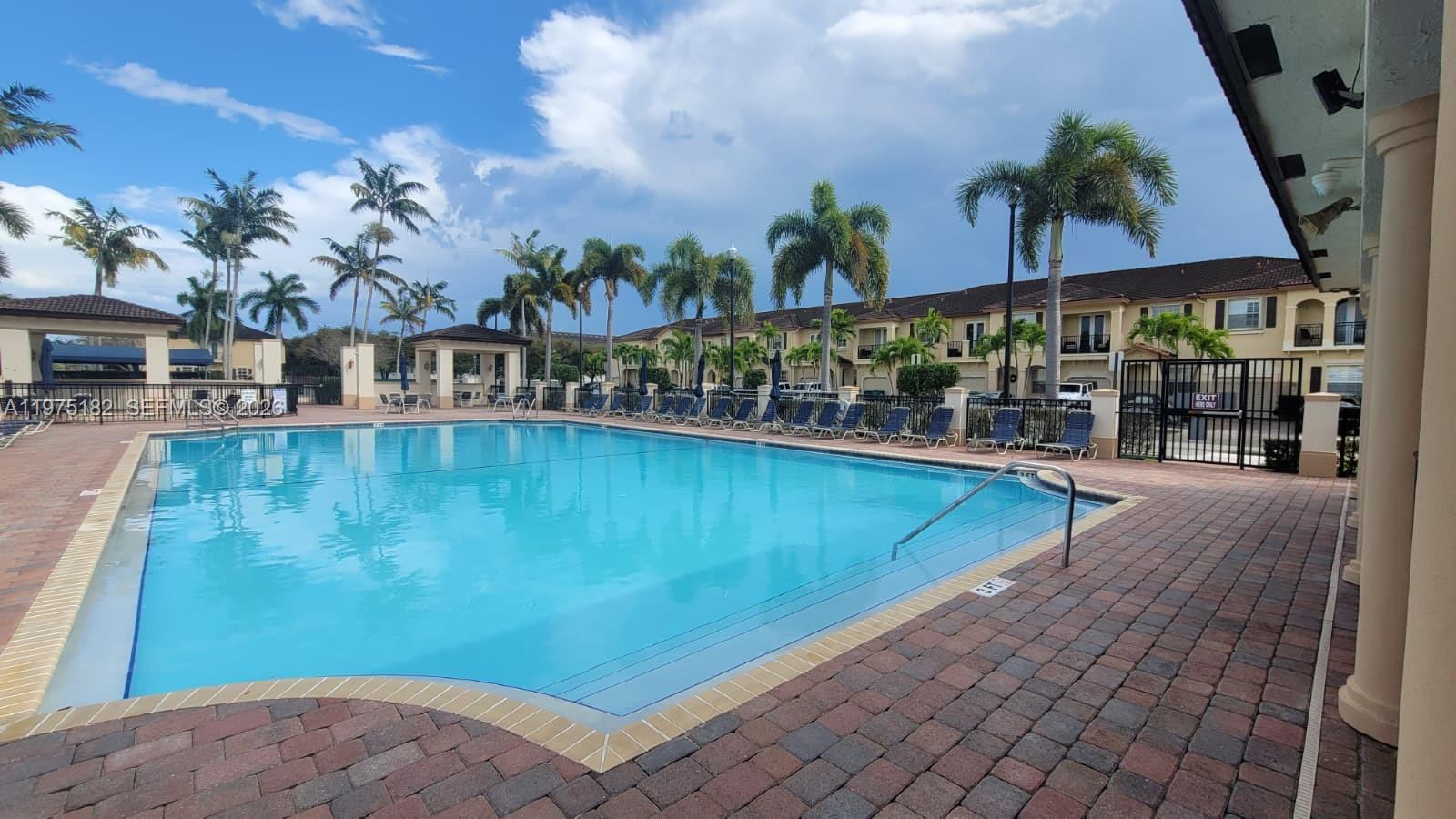 12842 Southwest 134th Street Miami, FL 33186 - Photo 19 of 22 a view of a swimming pool with a patio