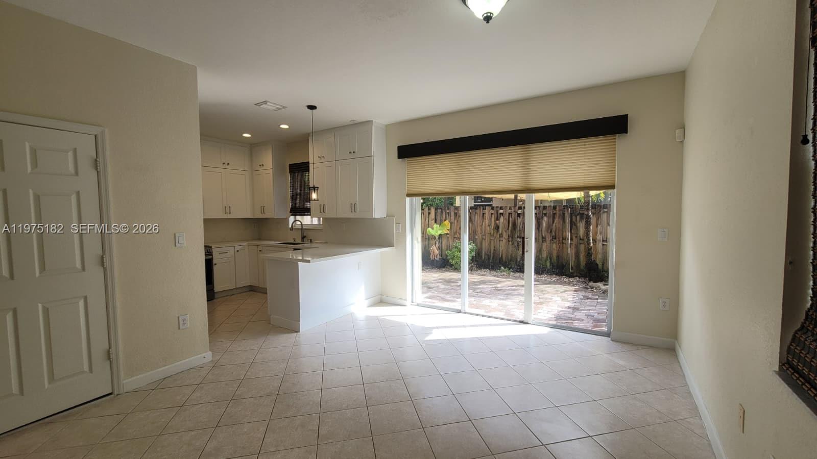 12842 Southwest 134th Street Miami, FL 33186 - Photo 6 of 22 a open kitchen with refrigerator and sink